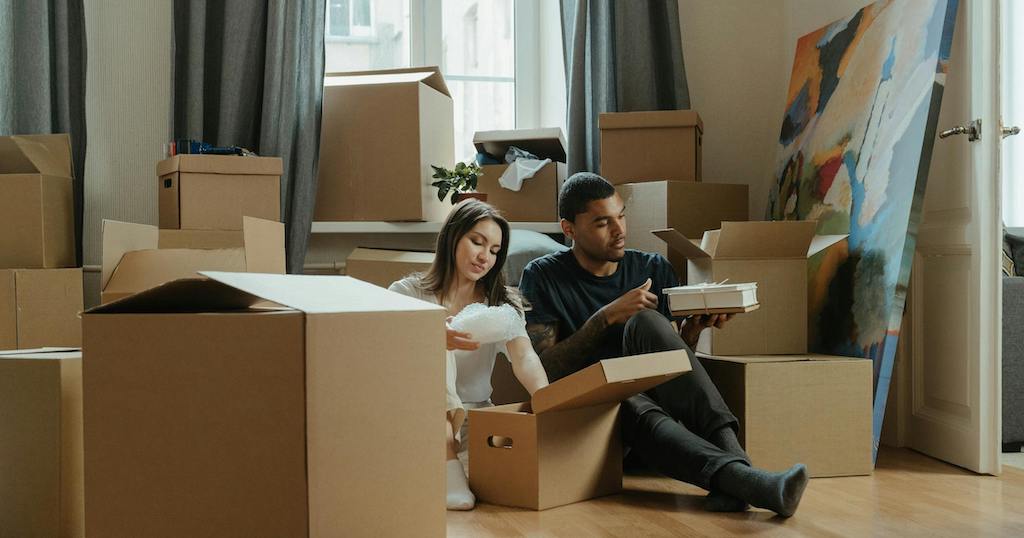 Couple packing moving boxes